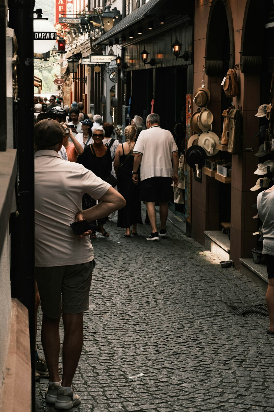 Photographer taking pictures of a queue of people on a city street