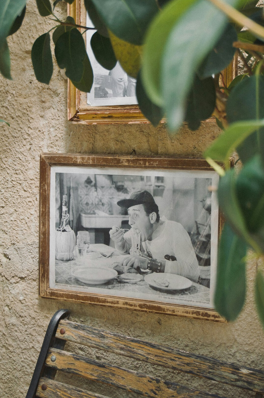 Stack of framed photographic prints on a wooden table