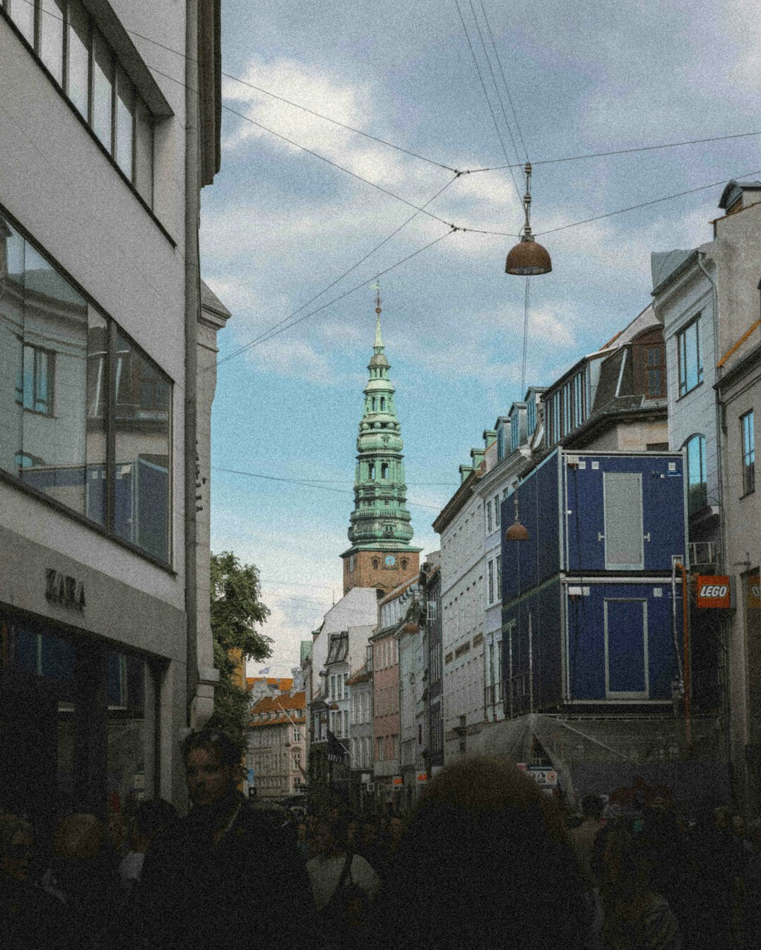 Vintage style photograph of a line of people on an old Danish street